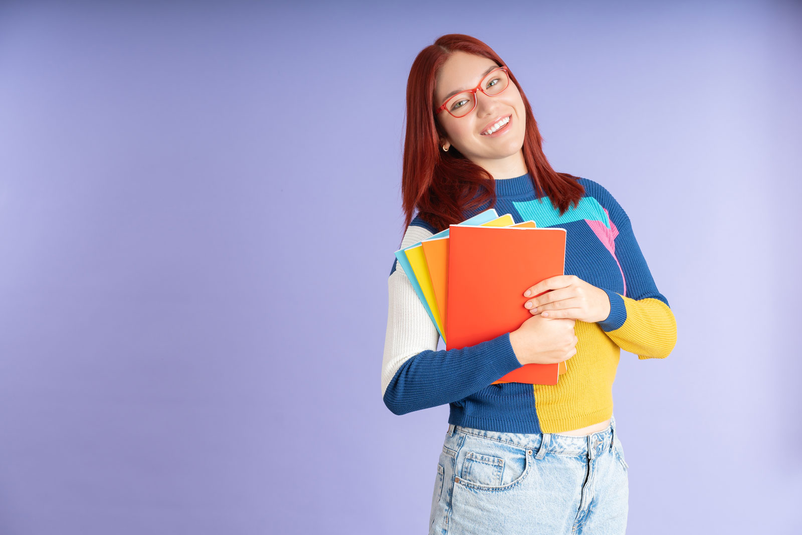 Étudiante qui sourit avec ses cahiers en mains