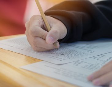 Elève qui écrit sur une feuille d'exercices